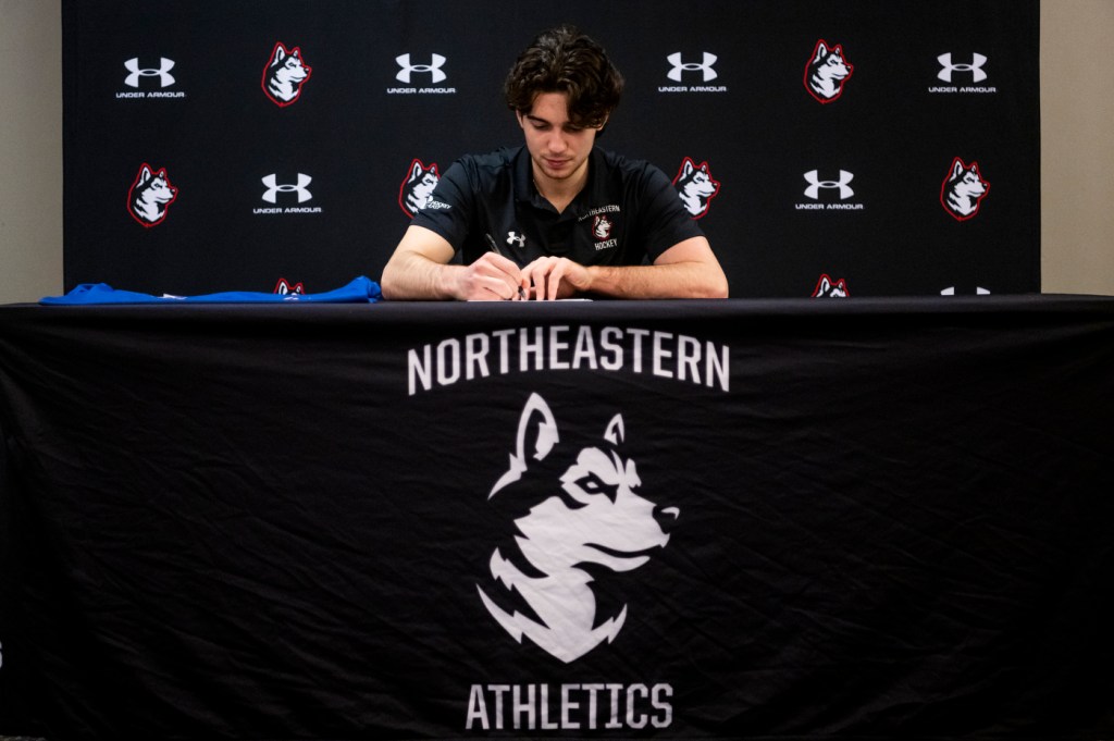 Devon Levi signing a contract with the Buffalo Sabres