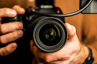 person holding Canon video camera