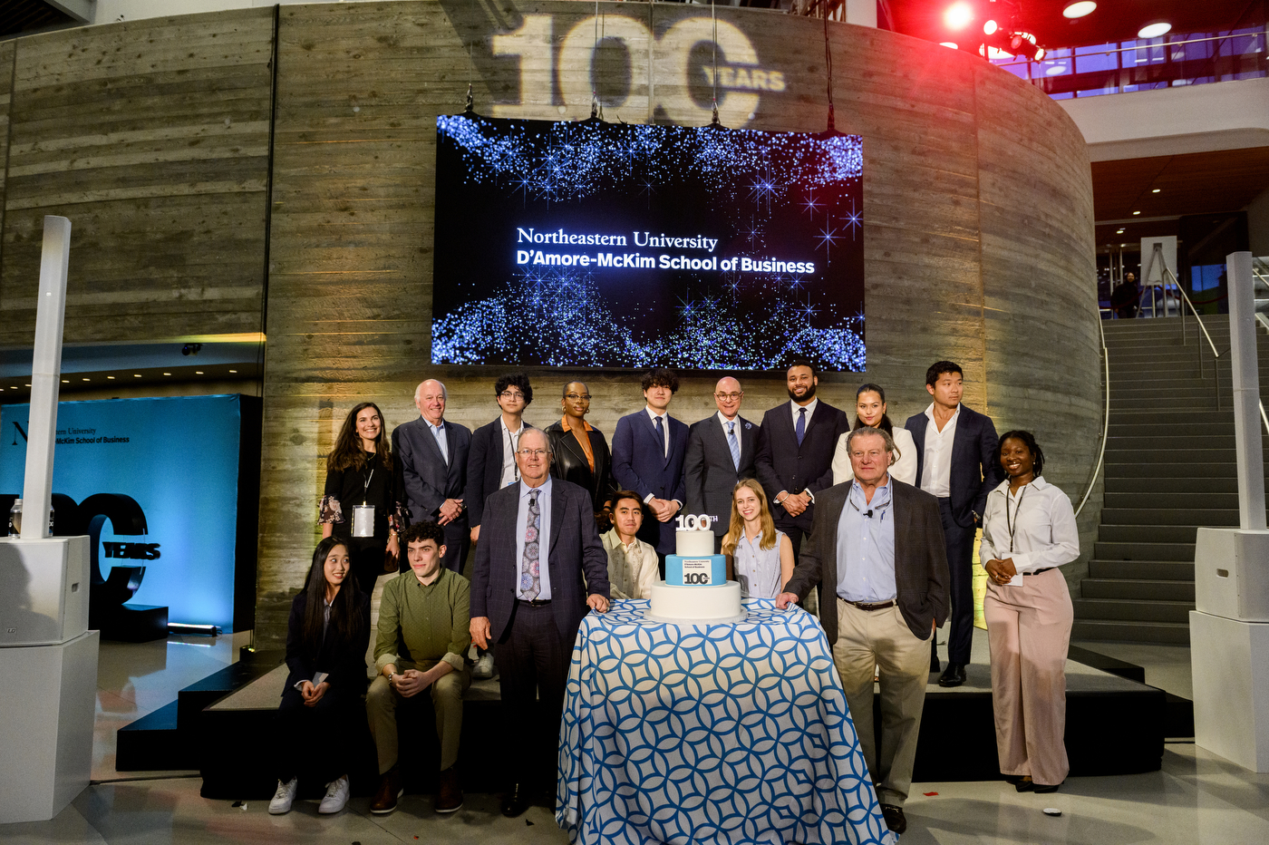 group of people posing for a photo at D'amore McKim's 100th Anniversary