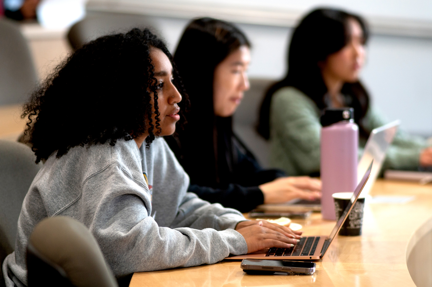 Northeastern Community members take notes on their laptops at the career conference