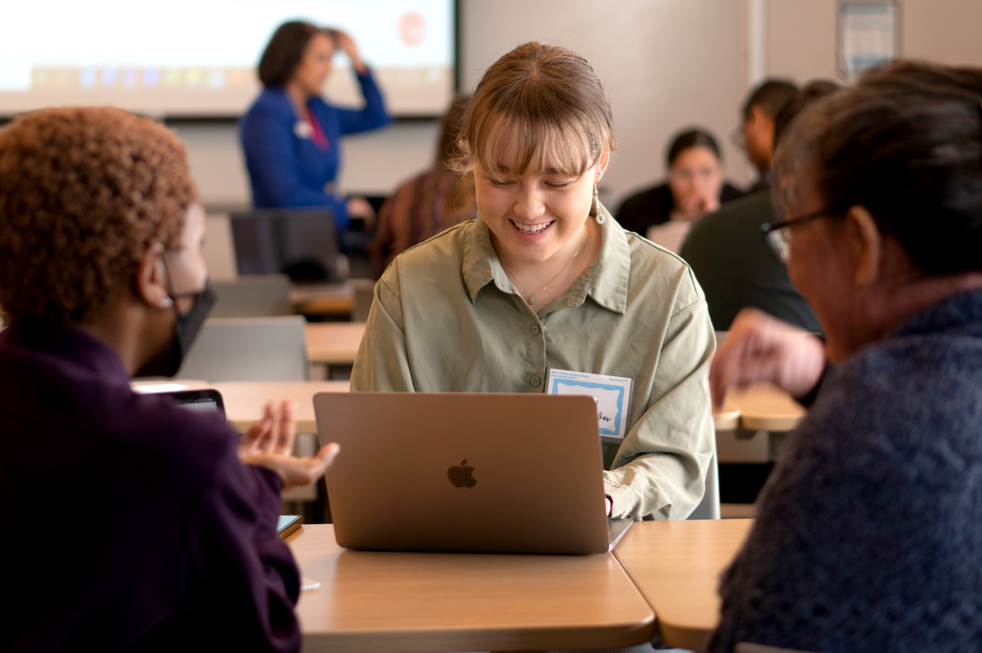 Northeastern University community member smiling while typing on their latop