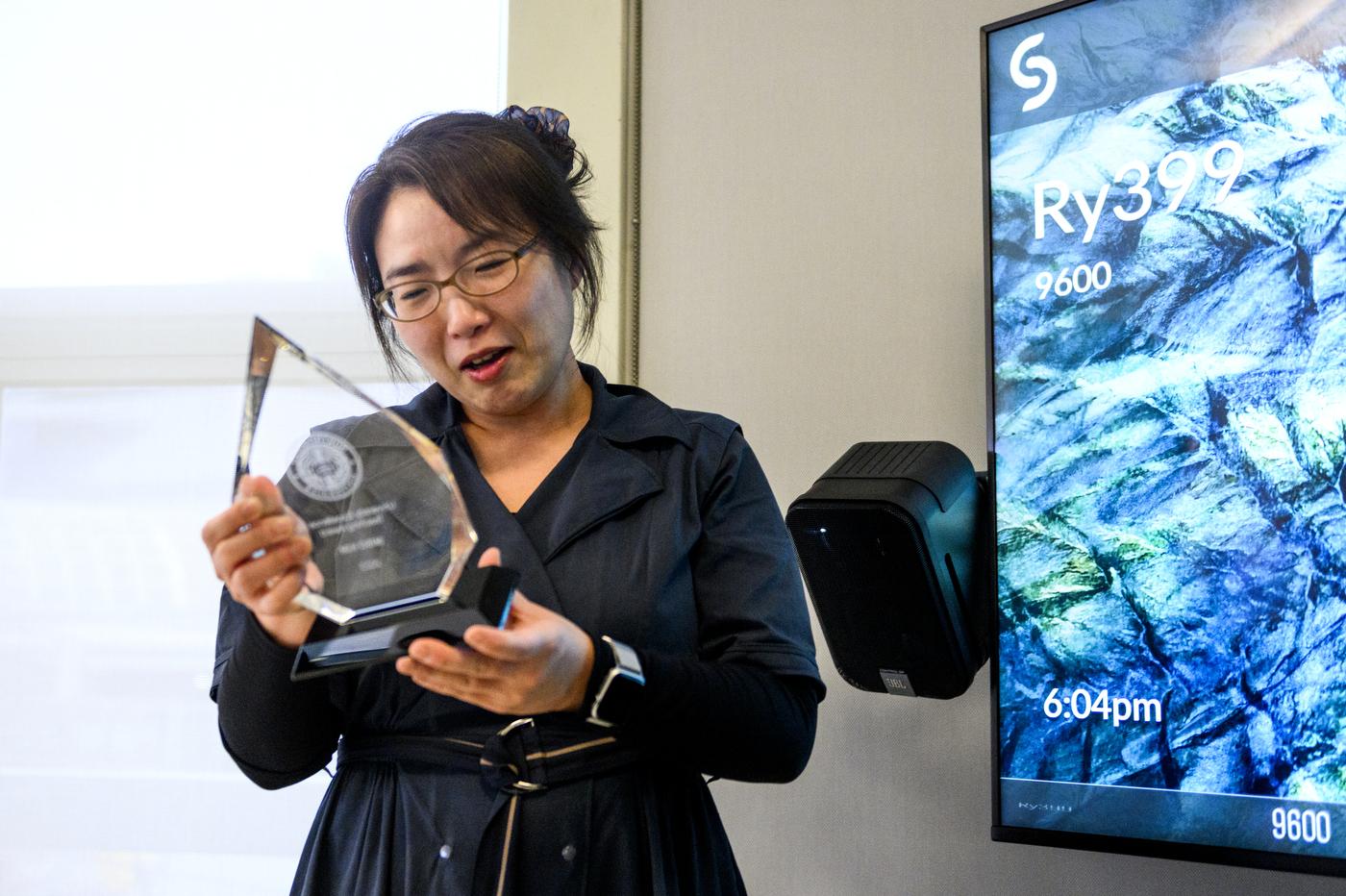 Professor Miso Kim holding the University Excellence in Teaching Award