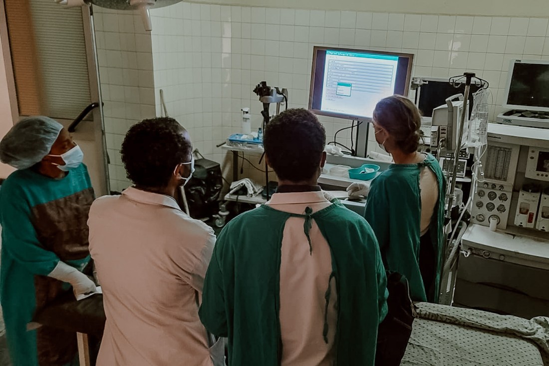 four health care workers looking at computer monitor