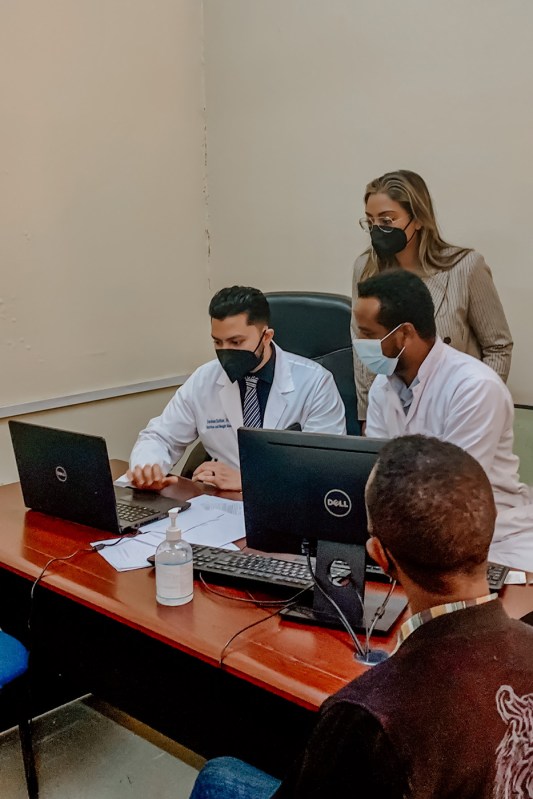 shital waters and three healthcare workers surrounding a laptop