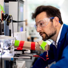 Nikolai Slavov wearing lab glasses while conducting alzheimers research