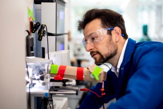 Nikolai Slavov wearing lab glasses while conducting alzheimers research