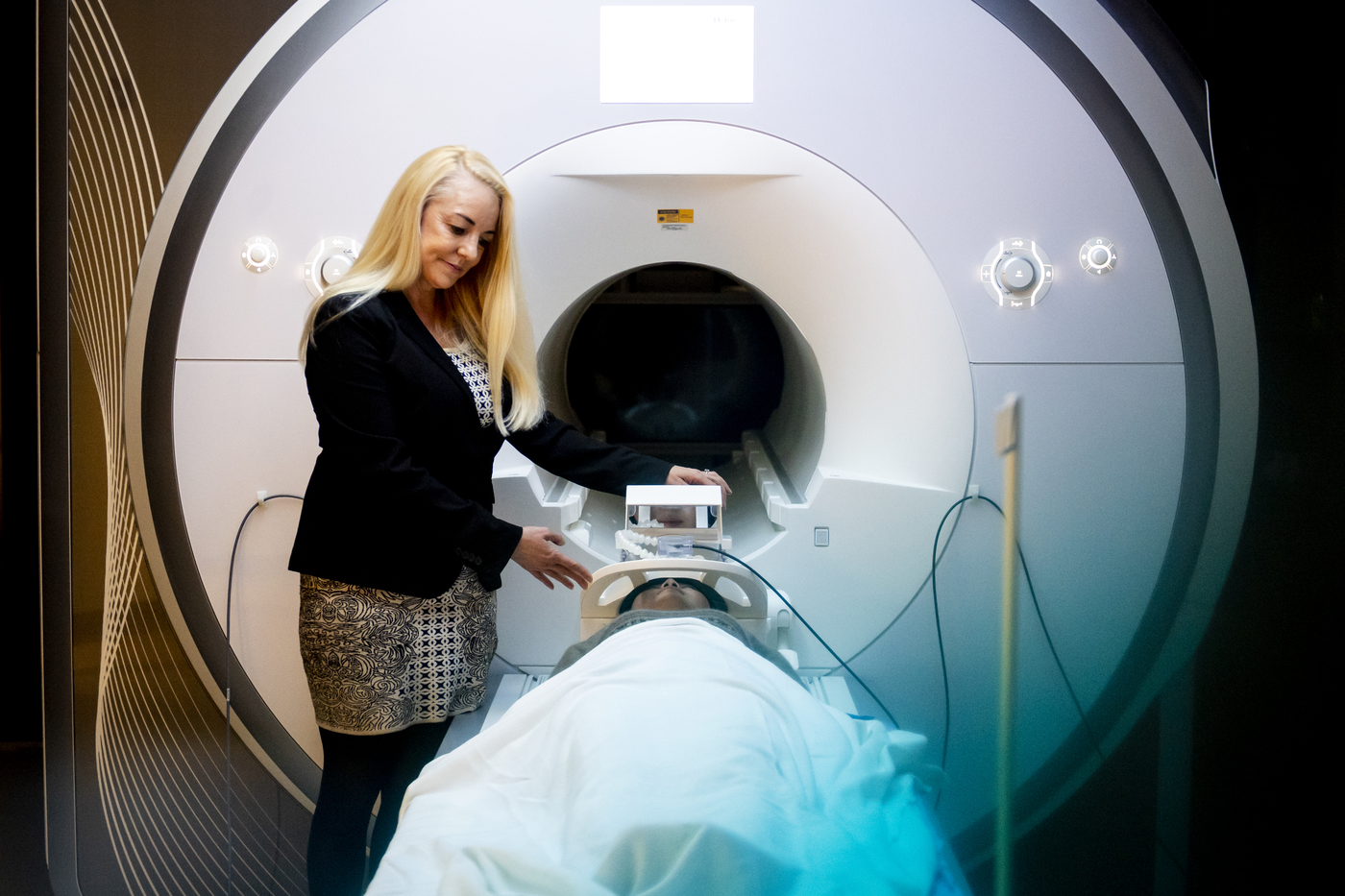 Susan Whitfield-Gabriel in front of a MRI machine