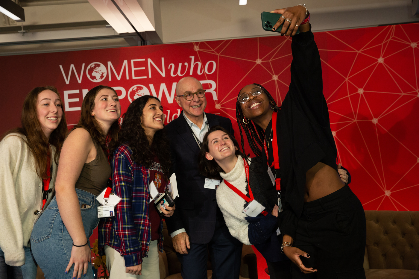 group of people taking a selfie with president joseph aoun at women who empower event