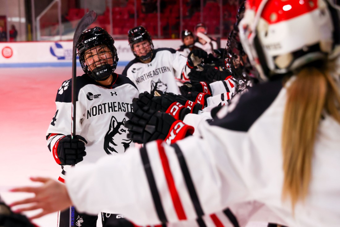 womens hockey players high fiving each other