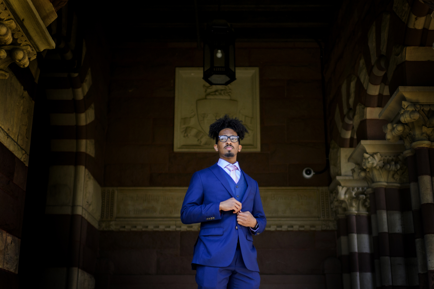 Omar Mohuddin stands at the entrance of the Woburn Public Library.