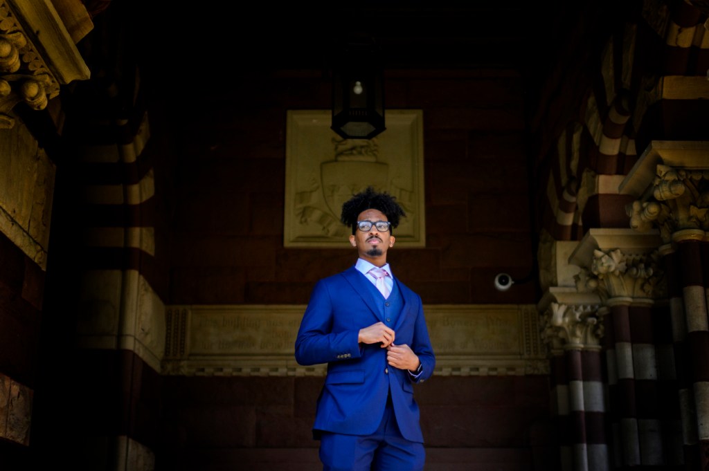 Omar Mohuddin stands at the entrance of the Woburn Public Library.