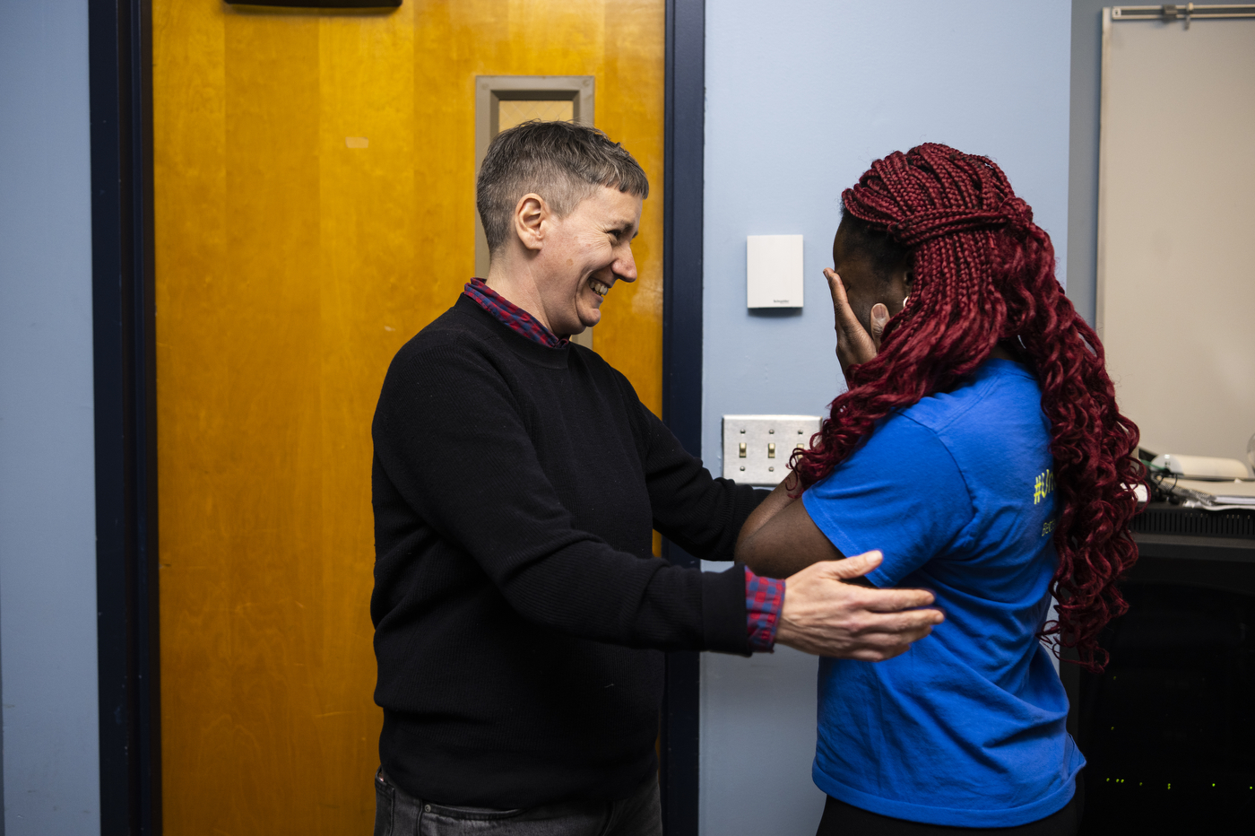 Nancy Riordan comforting Amara Ifeji