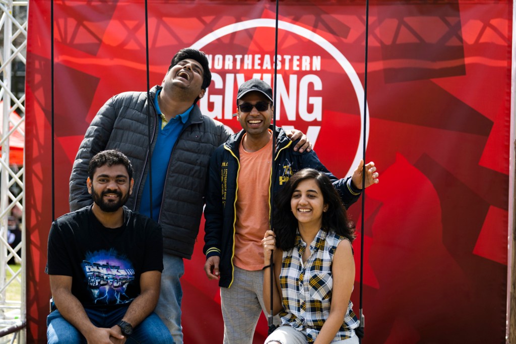 Northeastern students pose for photos and play games in Centennial Common during Giving Day 2023