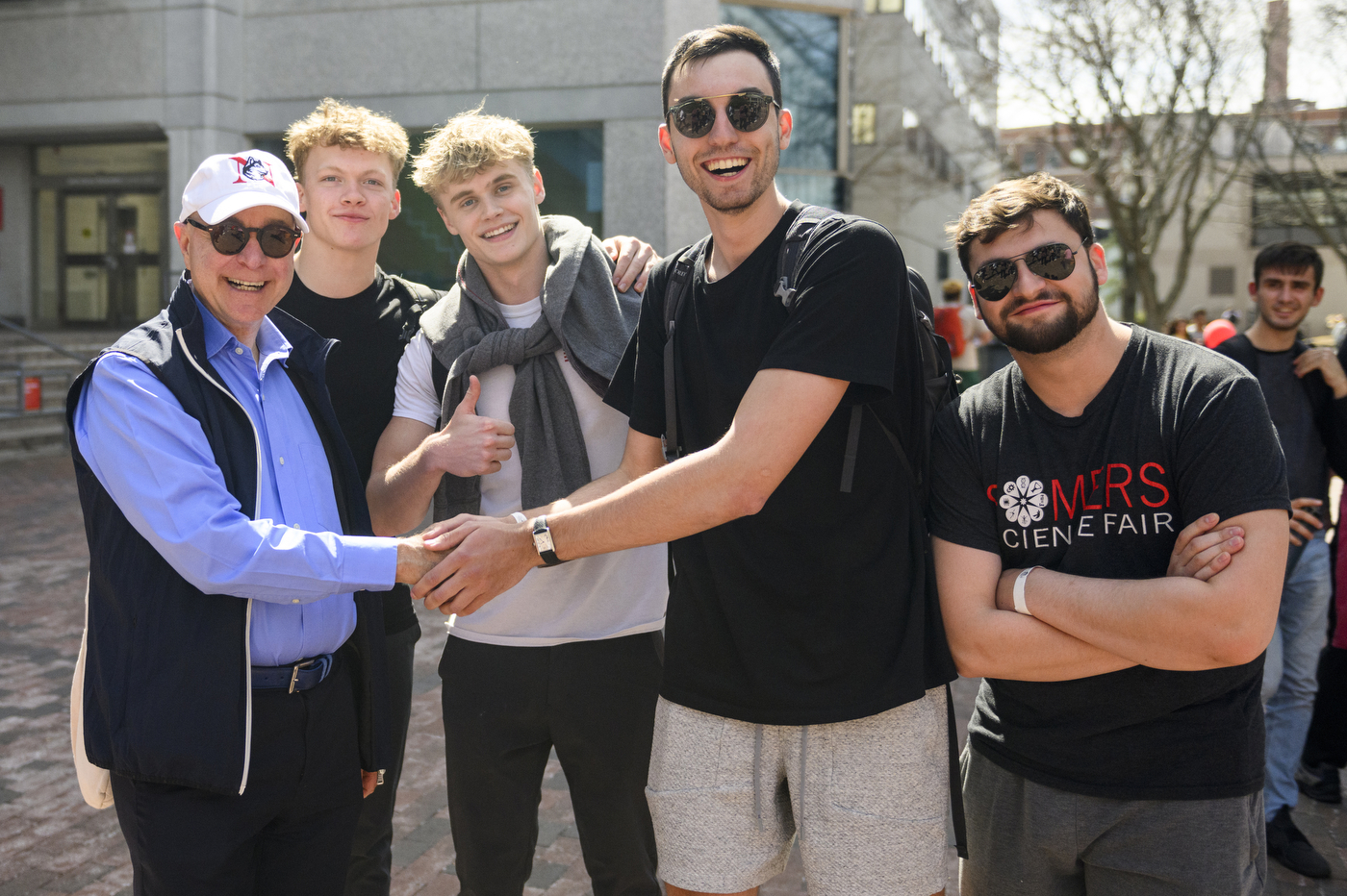 President Joseph Aoun posing with a group of Northeastern students