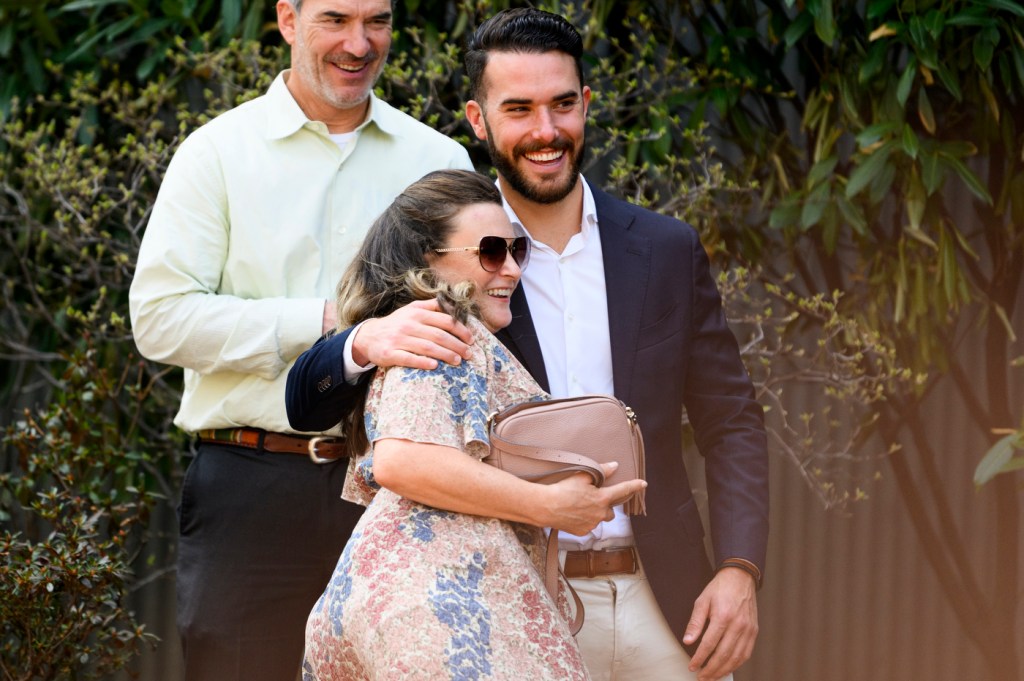 A man and woman embrace while smiling