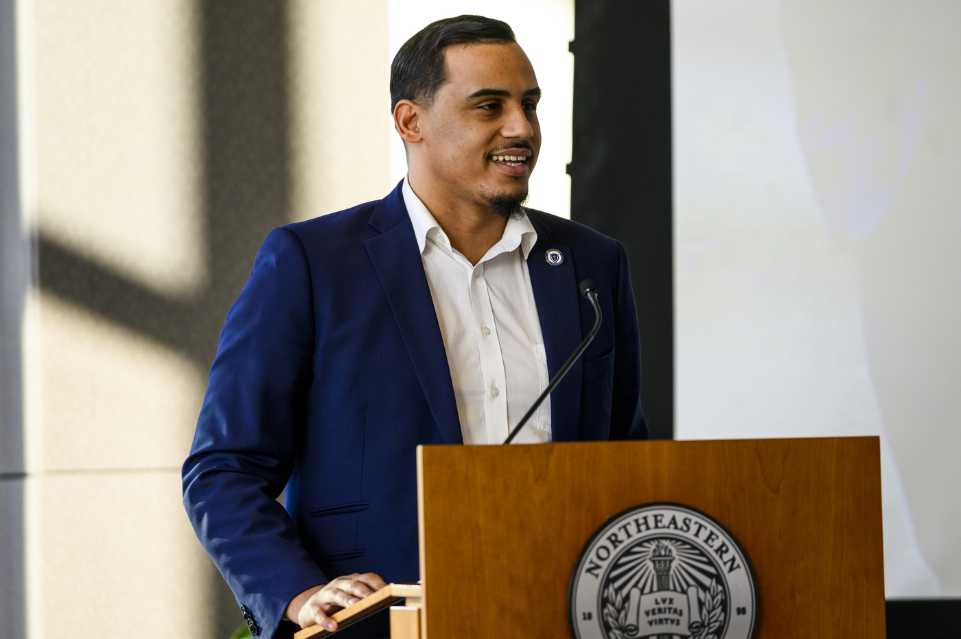 A person stands behind a podium with a microphone