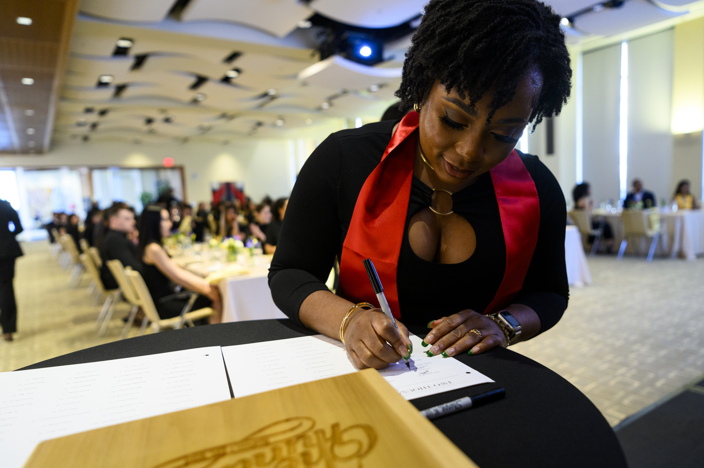 a person signs a book