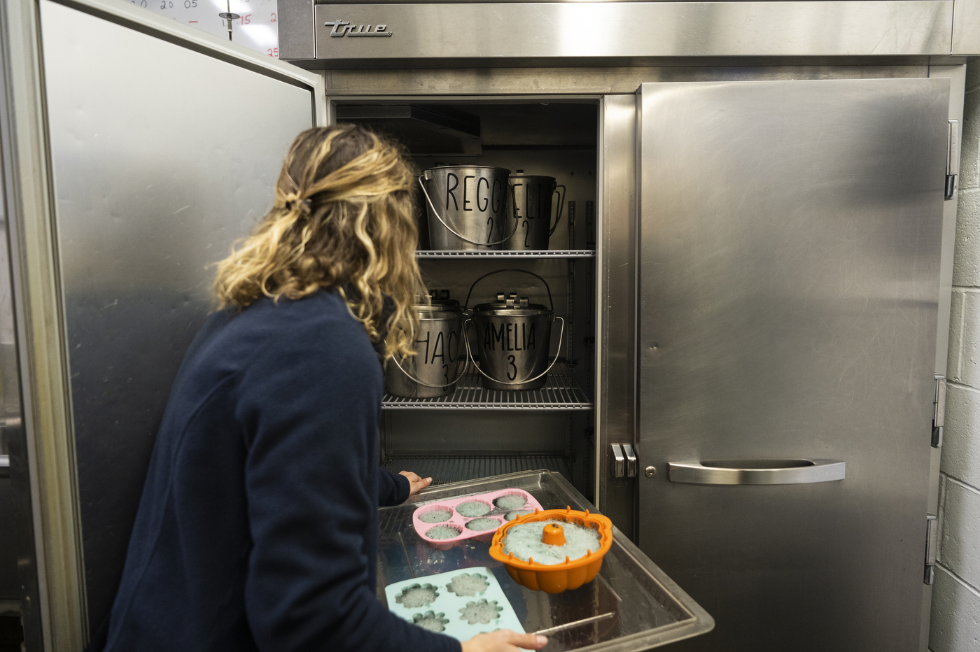 Isabelle Welch carrying a tray of jello to a freezer