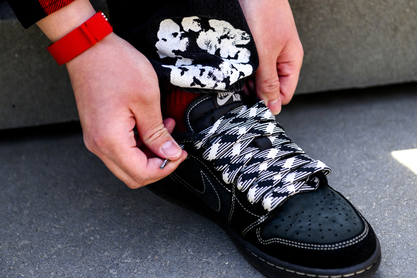 hands lacing up a pair of Nike Air shoes