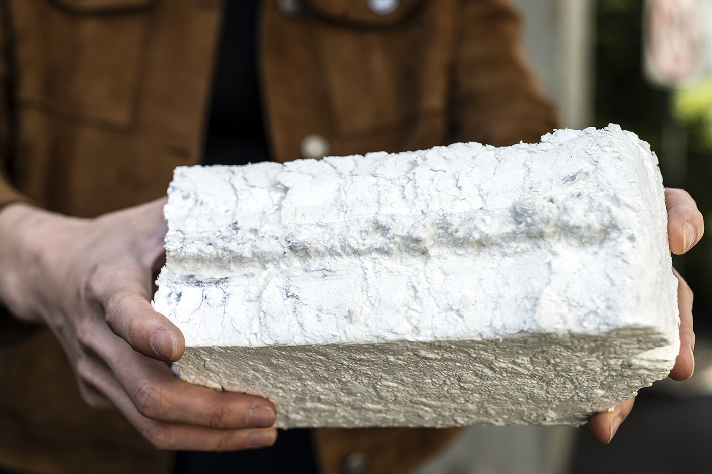 Ang Li holding a piece of styrofoam