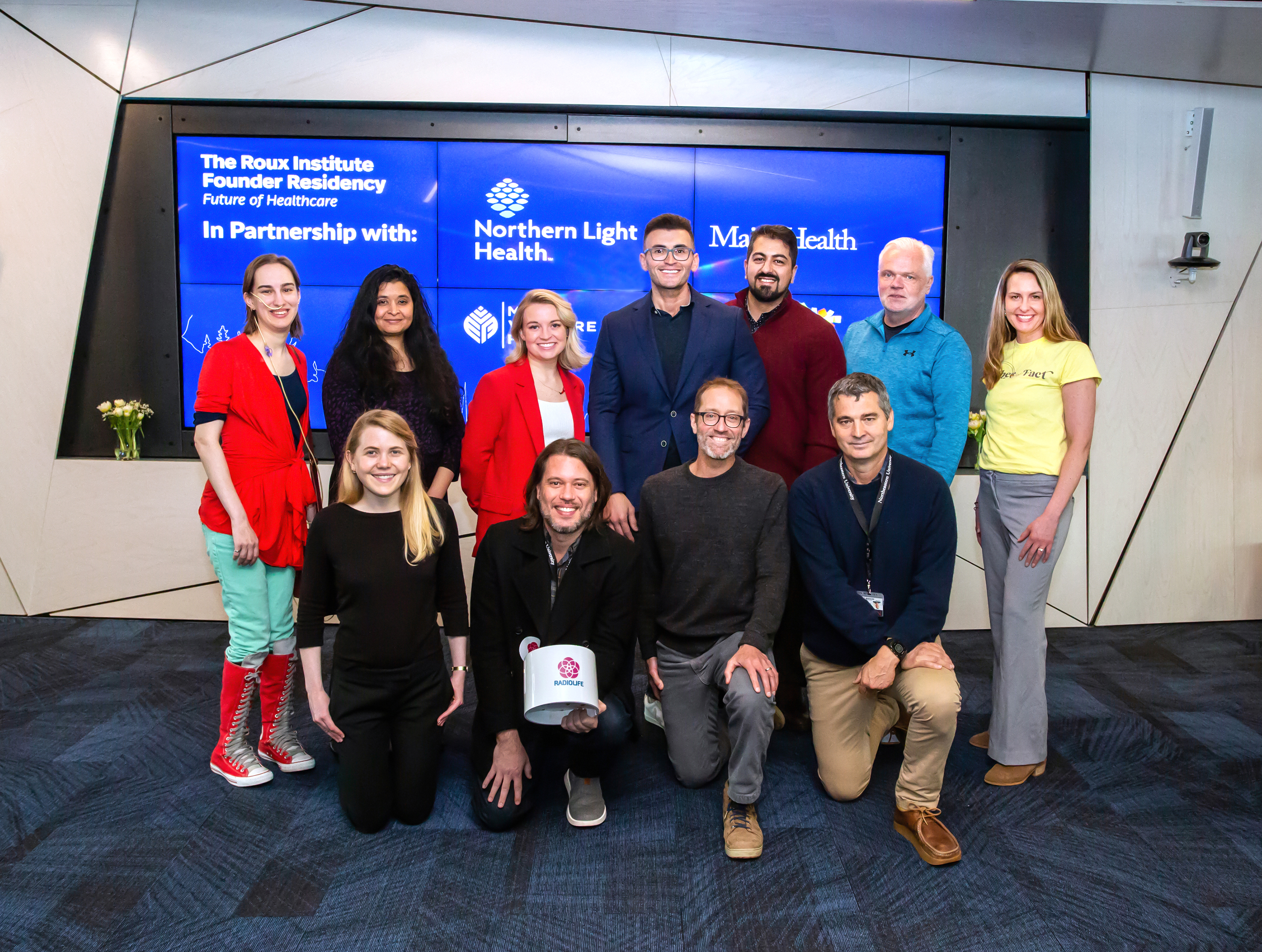 group of company representatives posing for a photo