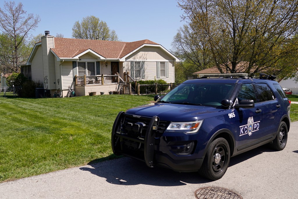 Police car parked outside of a home.