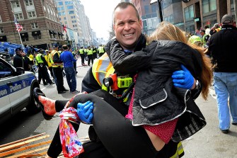 firefighter James Plourde carrying a bleeding Victoria McGrath