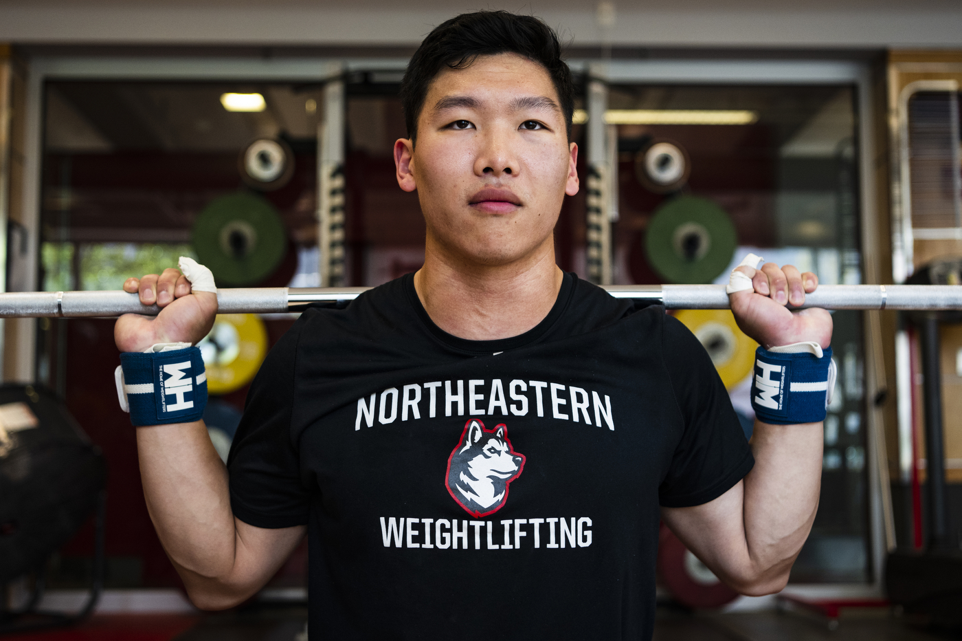 Matt Tung squatting a barbell