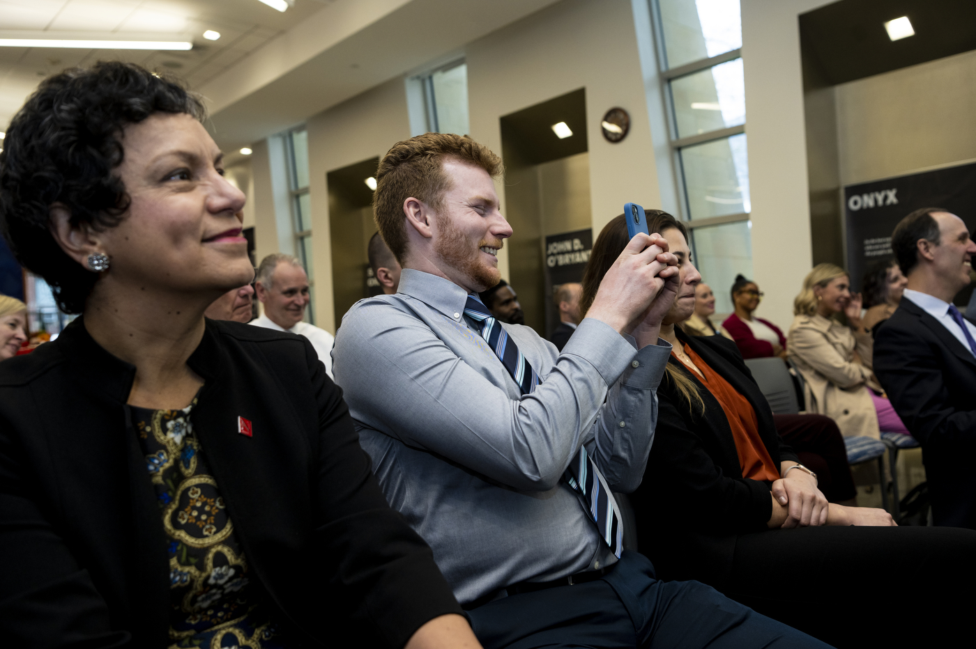 audience members smiling and taking photos