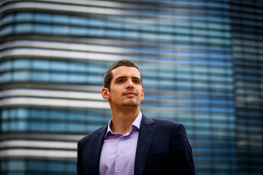 A man poses looking upward