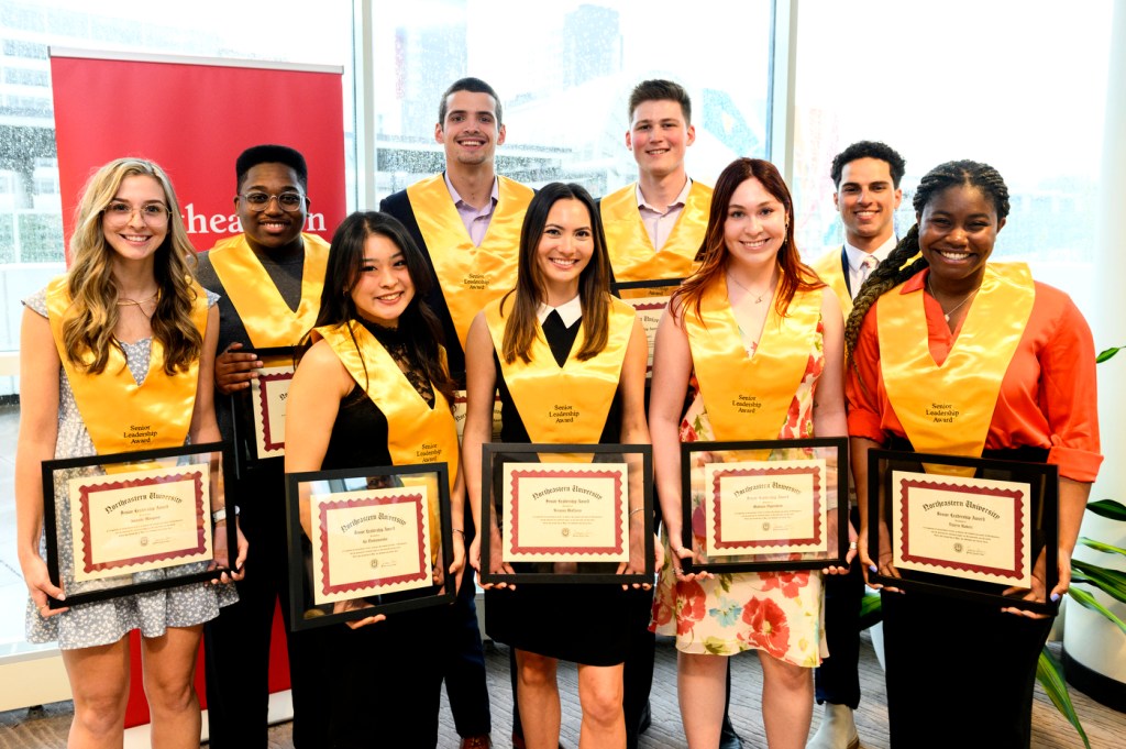 group of 9 students with gold sashes holding certificates