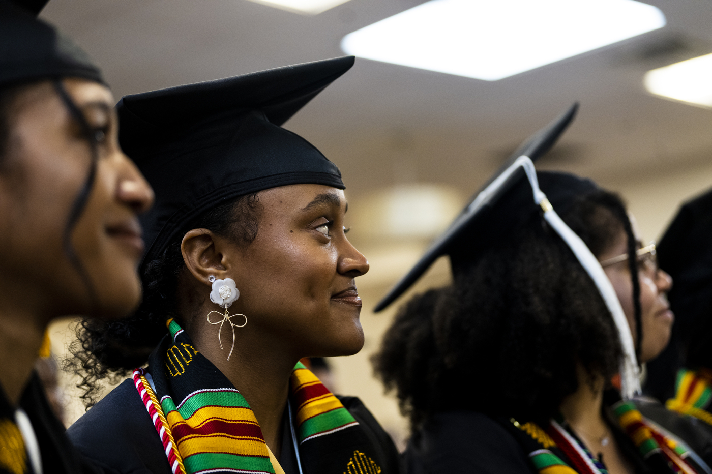 four graduates smiling