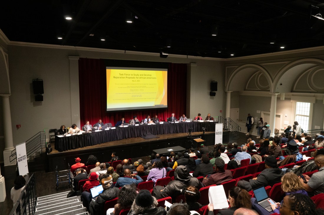 auditorium full of people attending a meeting regarding Black Reparations in California on campus at Mills College at Northeastern