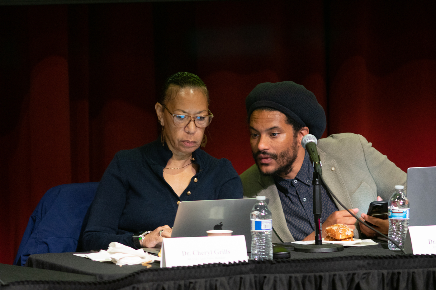 two people looking at one laptop screen