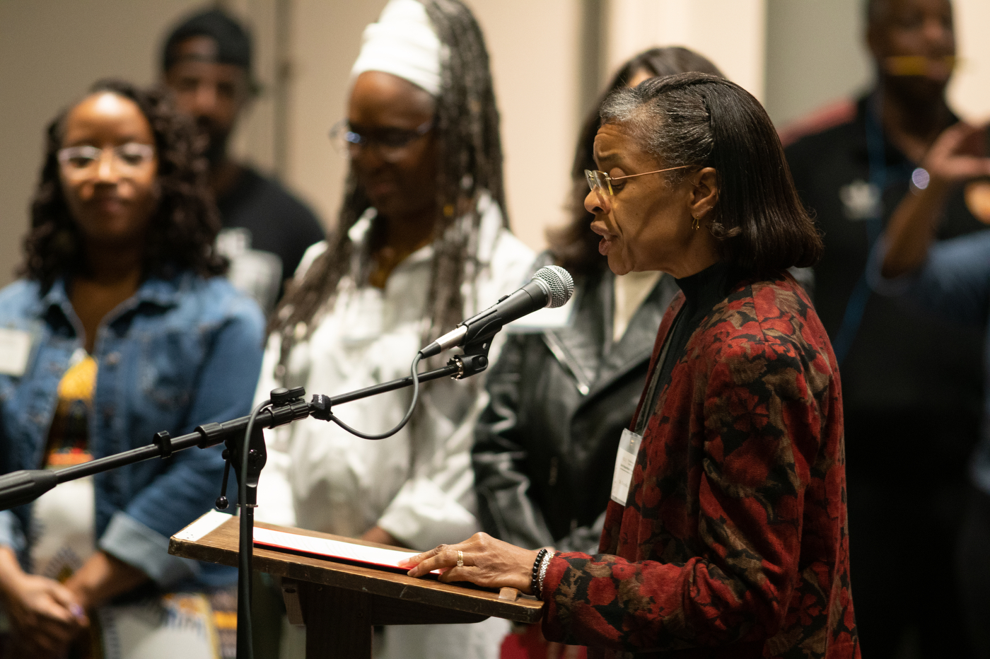 member of the California Reparations Task Force speaking into a microphone