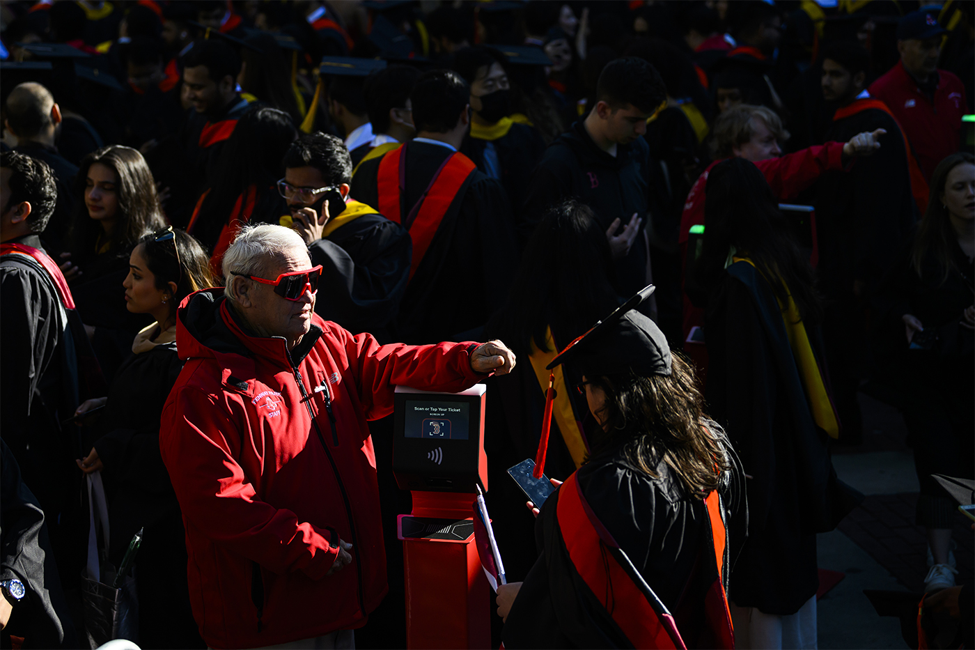 family member reaching hand out to student graduating