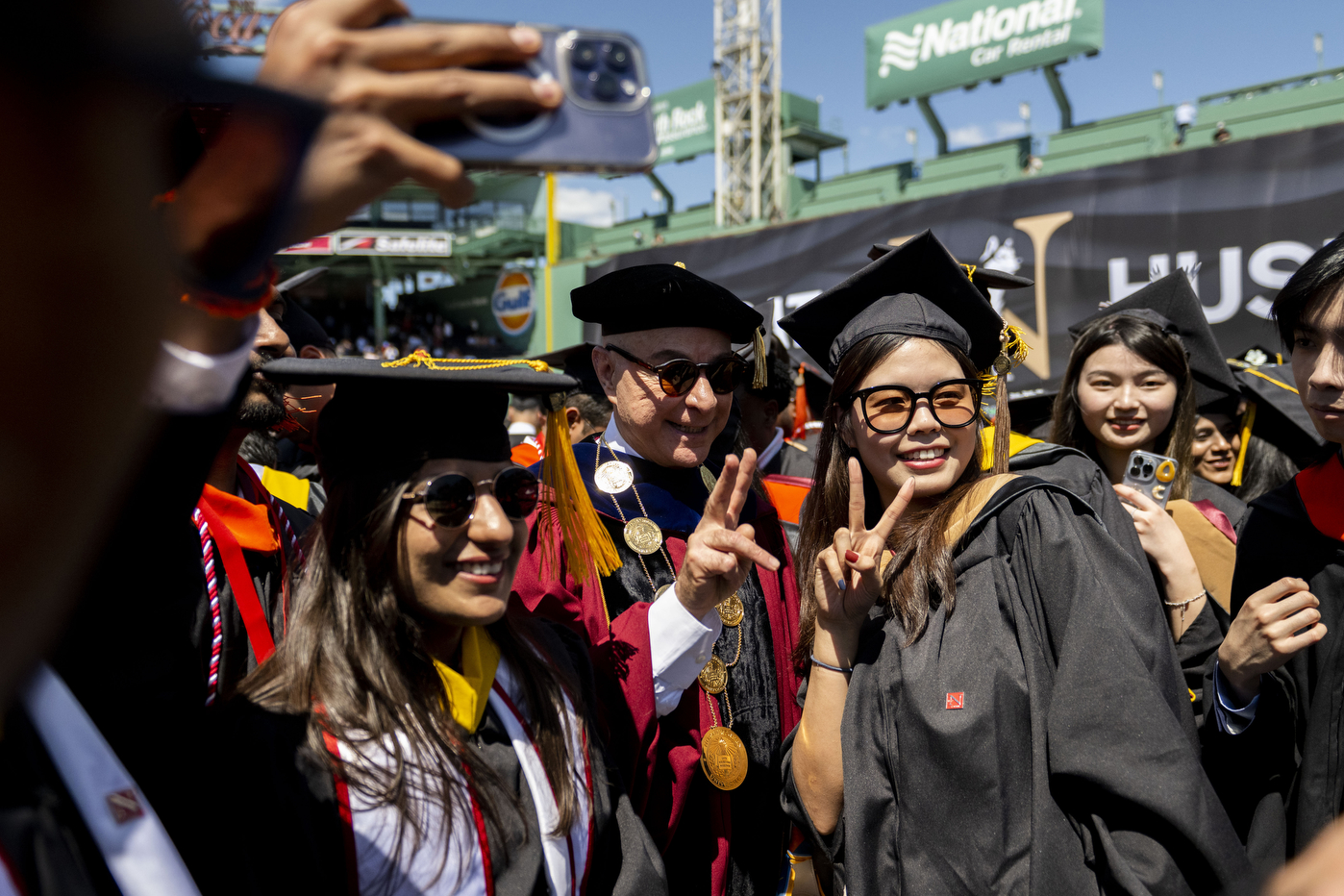 President Aoun posing for photos with graduates.