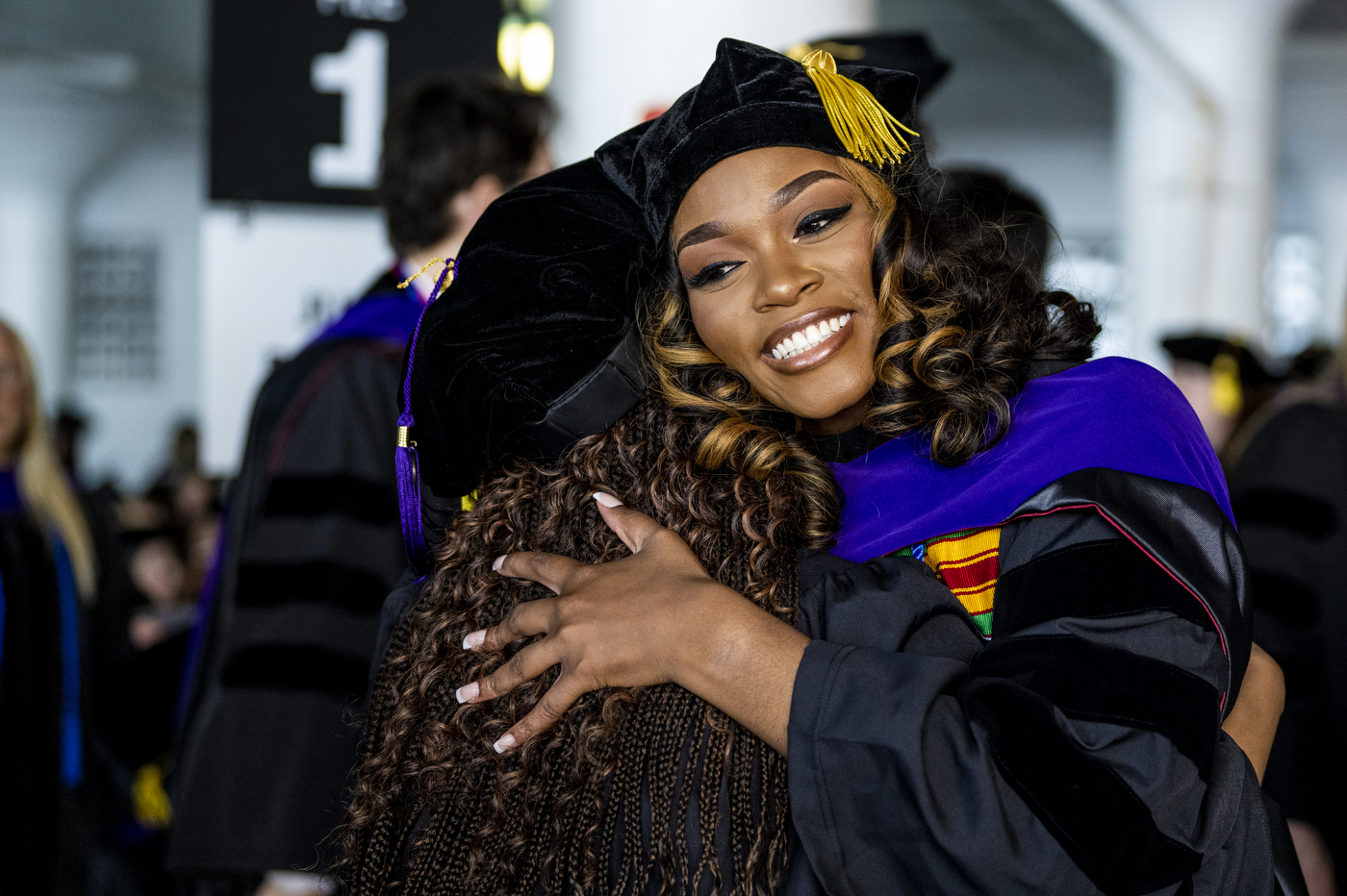 Northeastern School of Law graduates hugging.