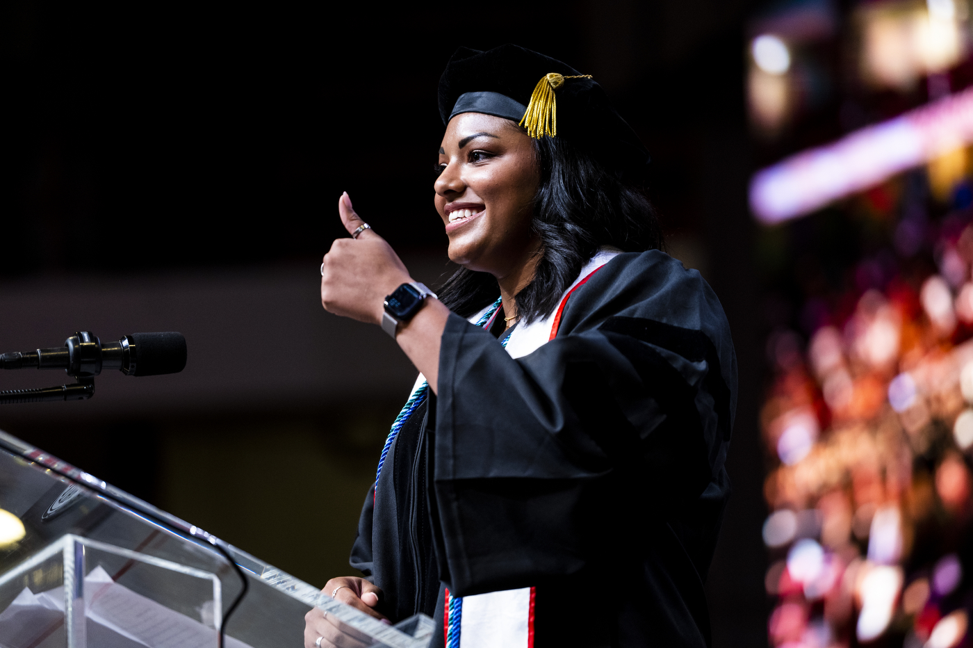 A Northeastern School of Law graduate speaks at a podium. 