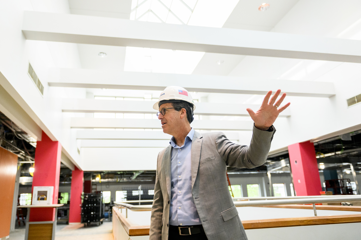 man wearing hard hat gesturing with one hand