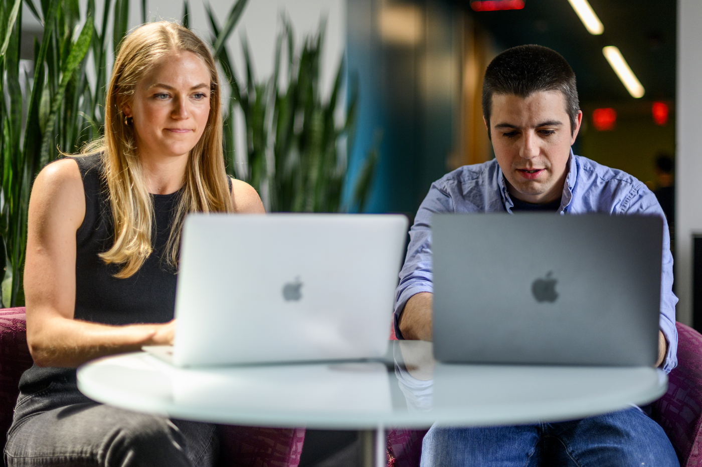 Kate Duffy and Thomas Vandal working on their laptops side by side