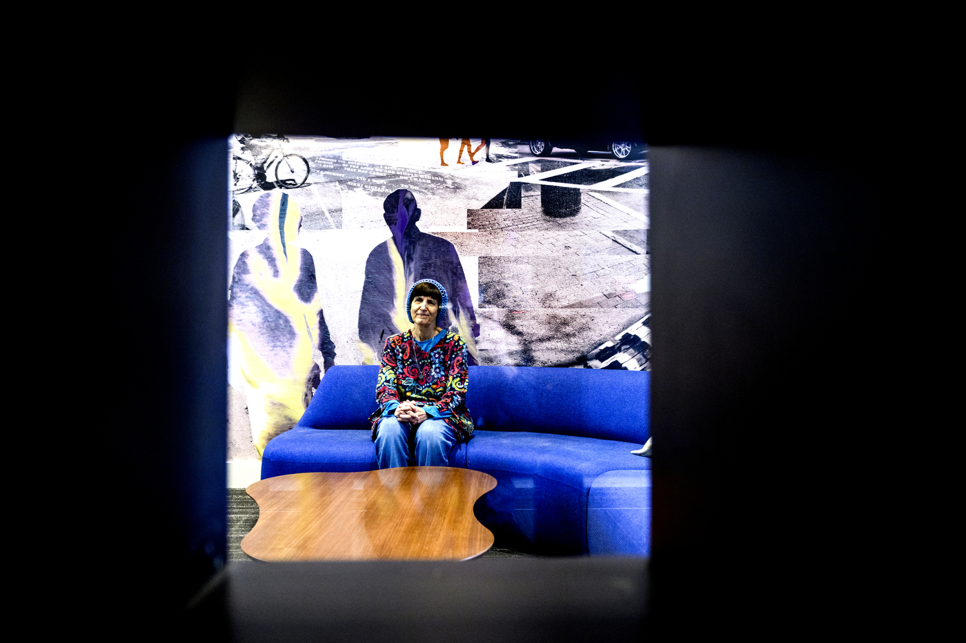 Donna Halper sitting on a blue couch