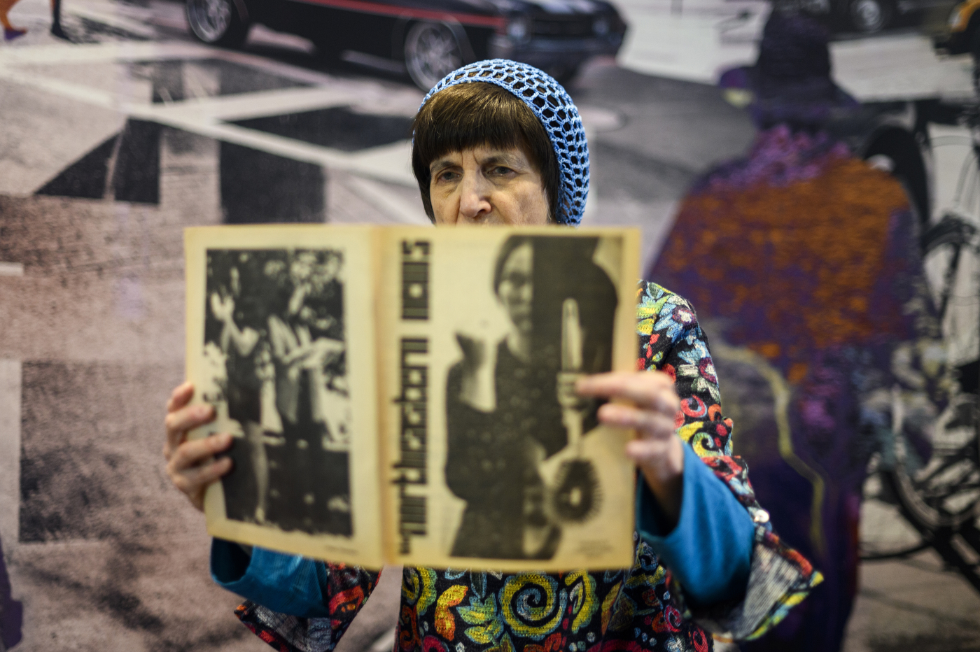 Donna Halper holding a copy of a Northeastern newspaper from the 1960s