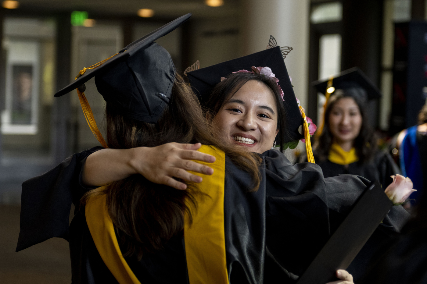 graduates hugging each other