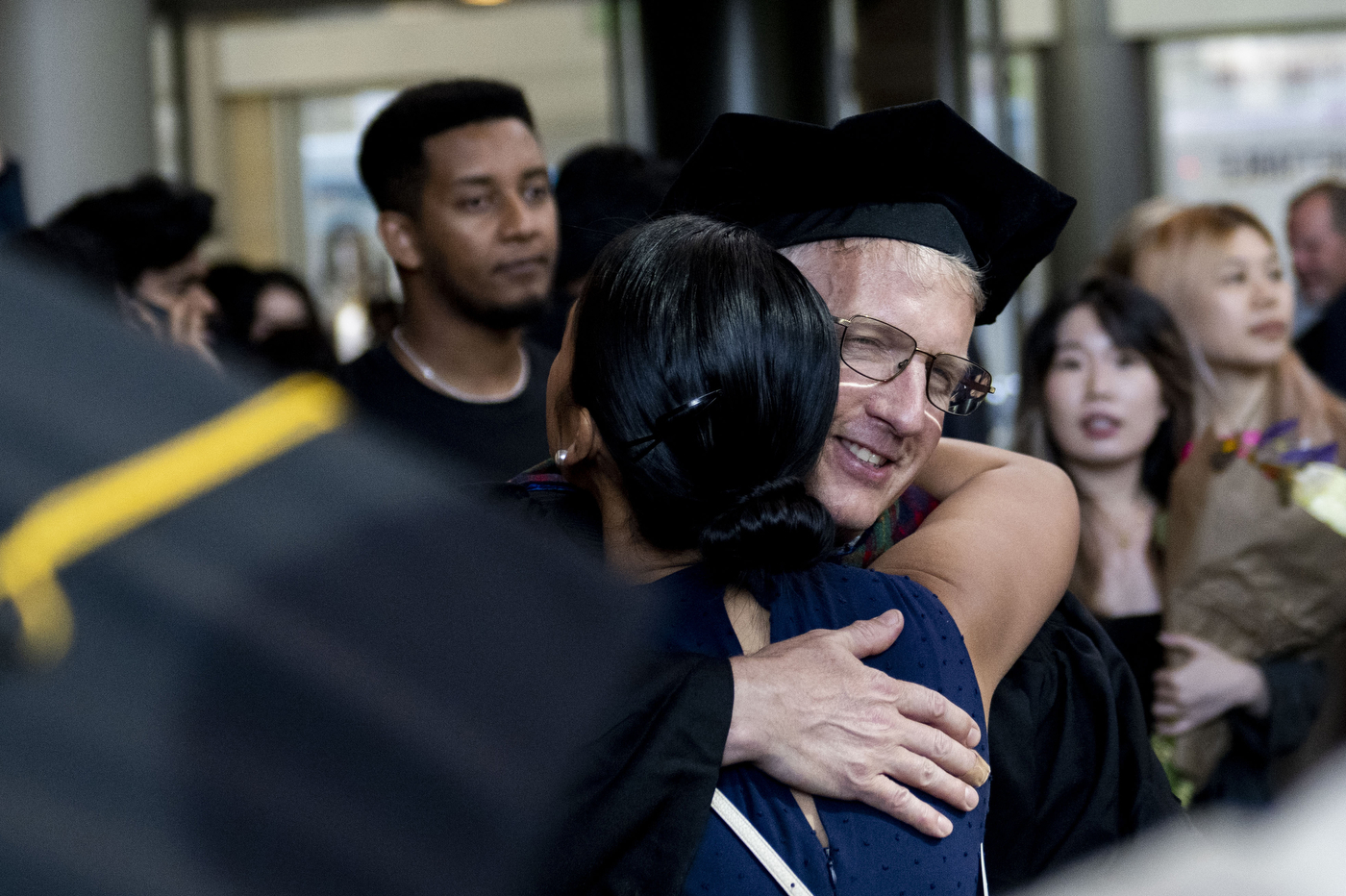 graduates hugging