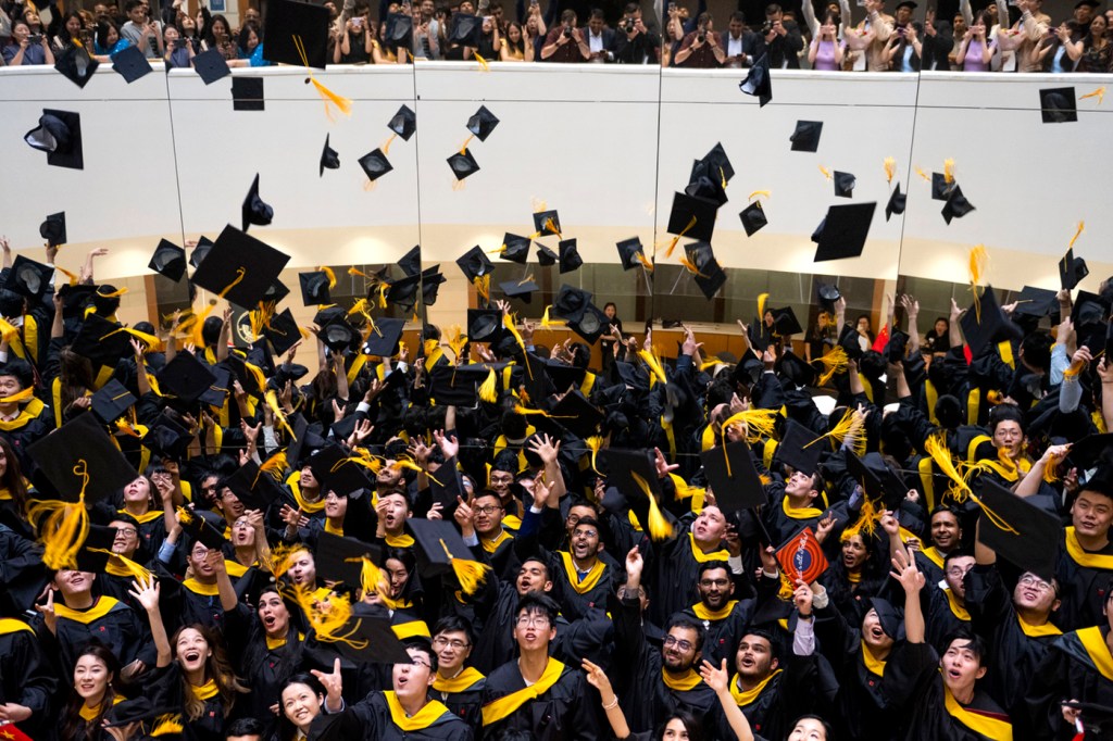 graduates throwing their caps in the area at Vancouver convocation