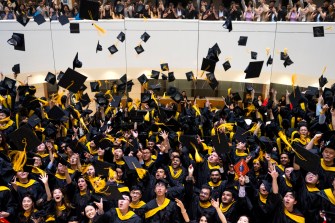 graduates throwing their caps in the area at Vancouver convocation