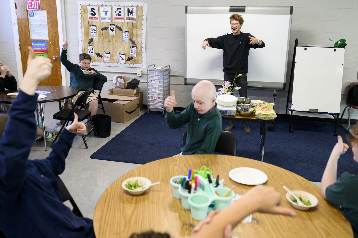 students working with microgreens in a classroom