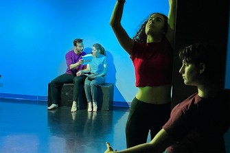 Students acting on stage in a theatre performance