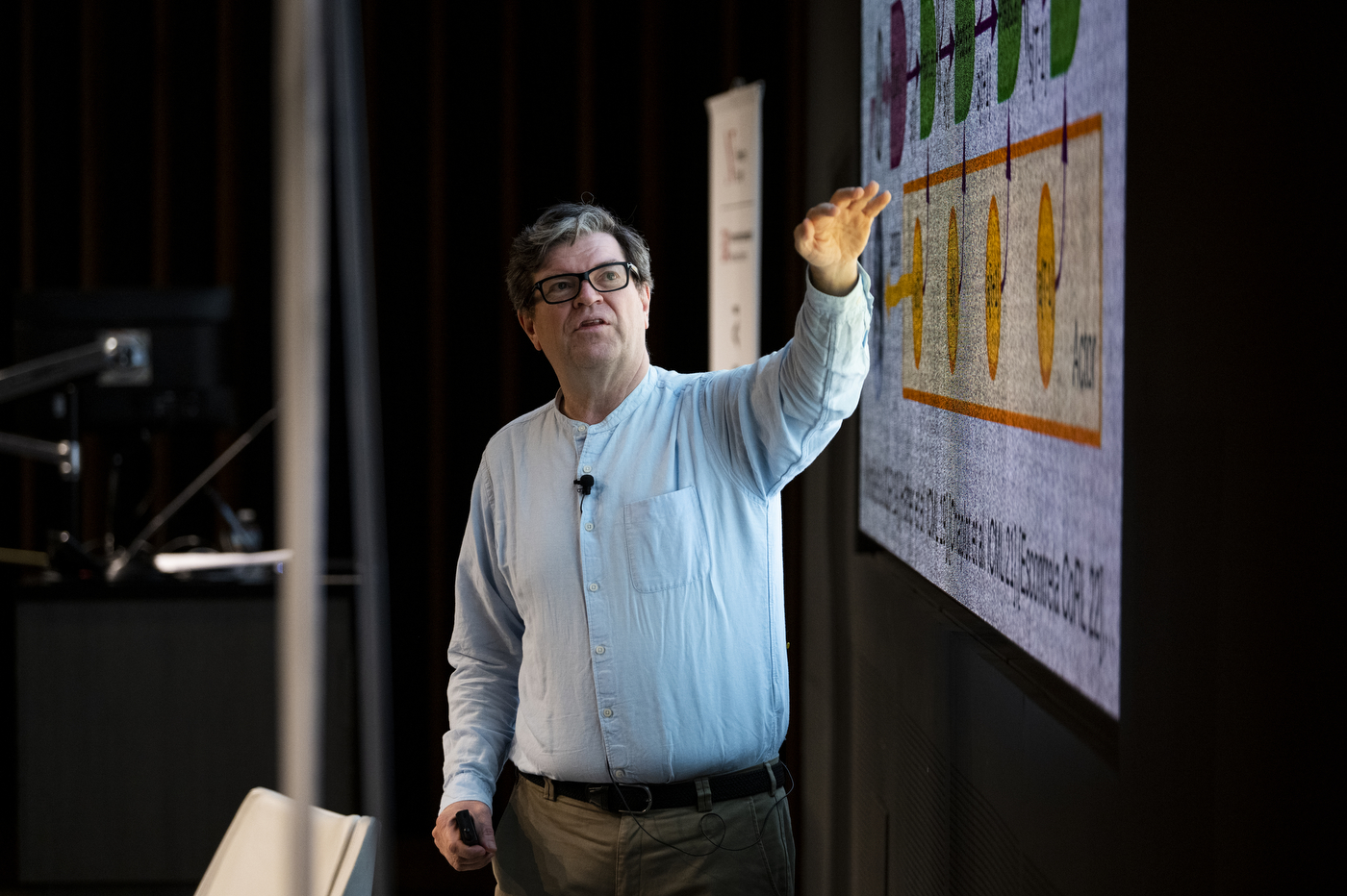 Yann LeCun gesturing to a visual at a Northeastern fireside chat